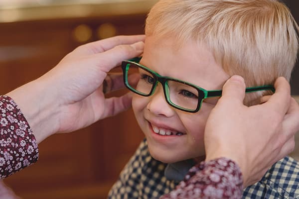 Young Boy Trying On New Glasses